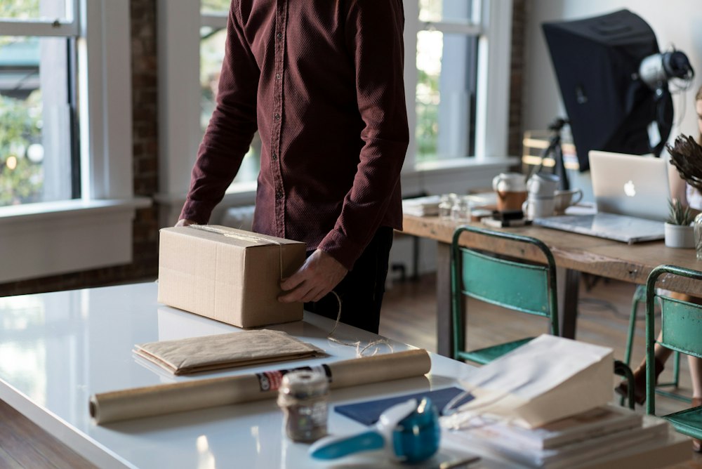 Online shop owner packing an order